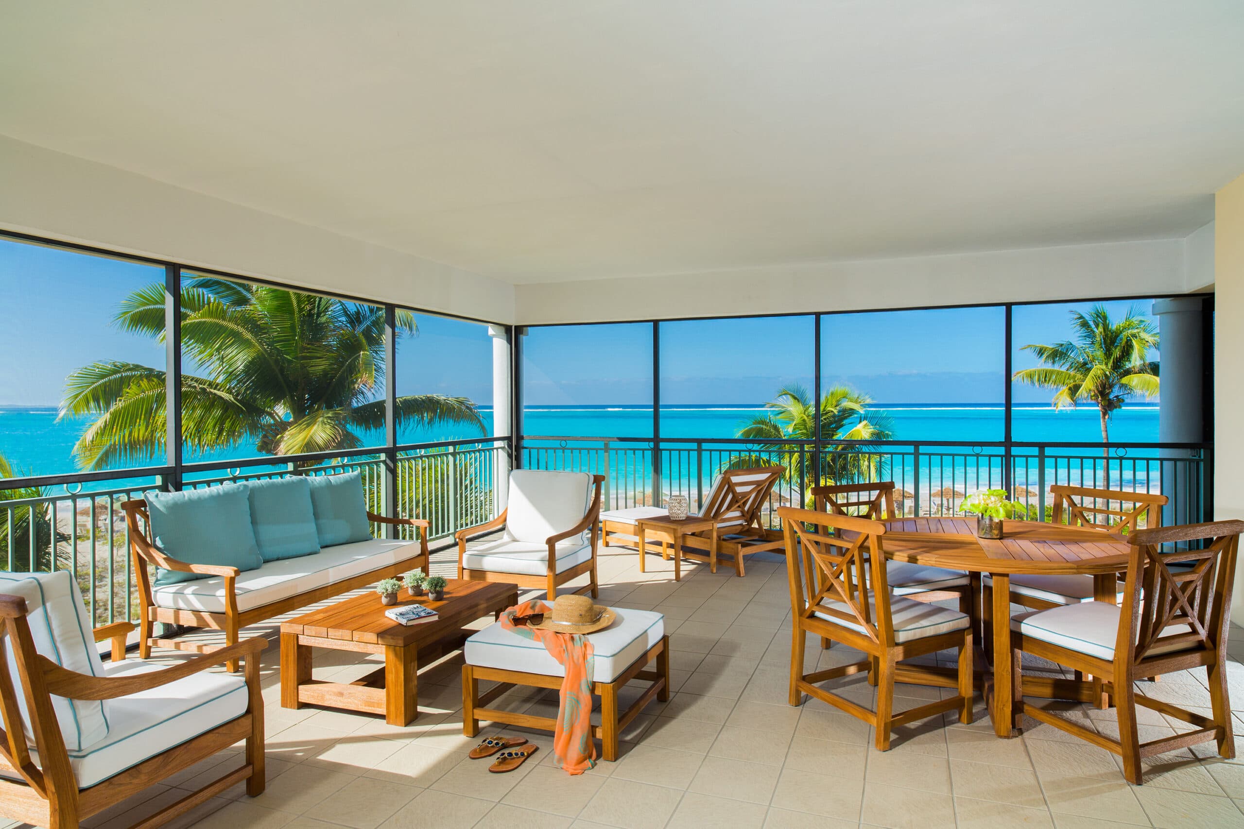 Ocean-front suite living area with wrap-around balcony at The Sands at Grace Bay