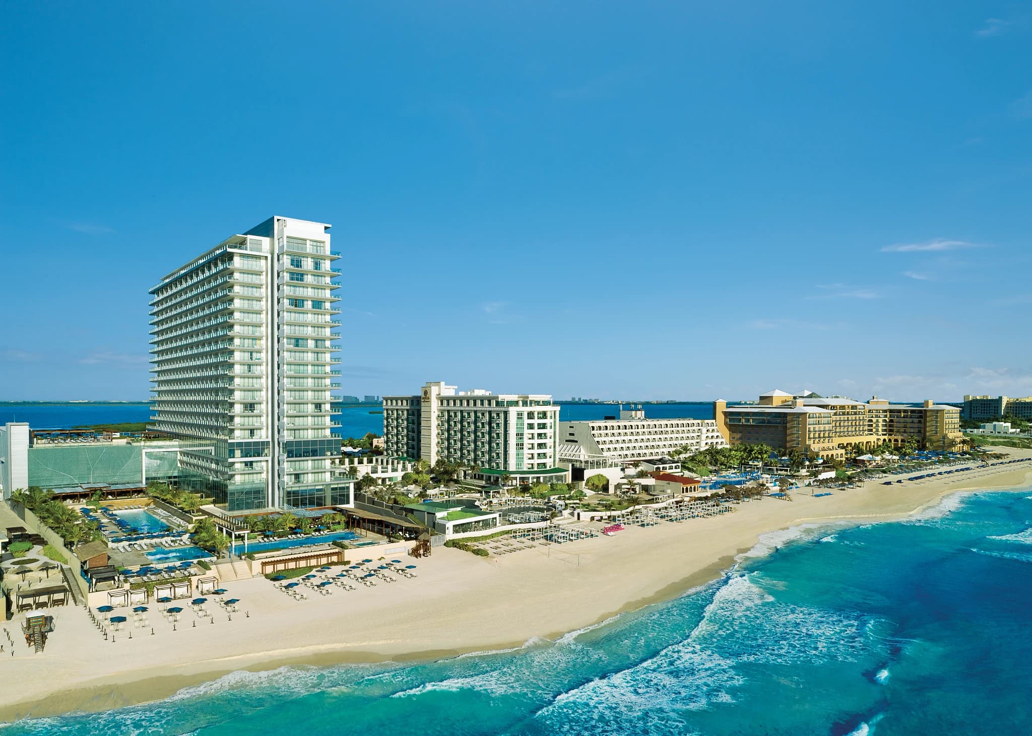 Aerial view of Secrets The Vine Cancun beachfront and pools